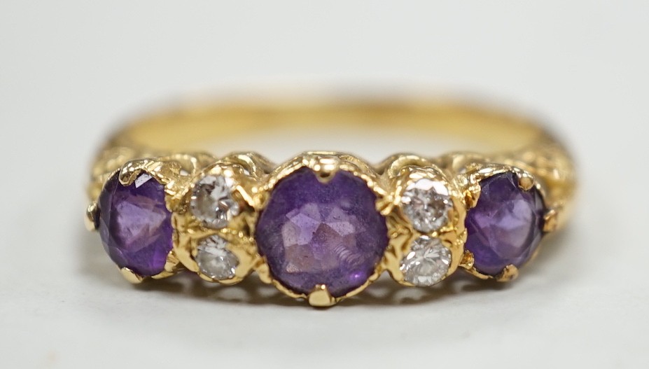 An 18ct, three stone amethyst and four stone diamond set half hoop ring, size Q/R, gross weight 4 grams.